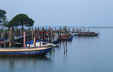 Fototapeta na wymiar boats in the Sea at sunrise in the Burano near Venice in Italy