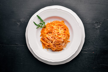Pasta con pomidorro. On a wooden background. Top view. Free space for text.