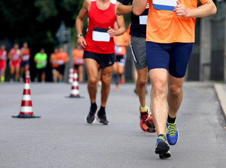 Fototapeta premium Racing and athletes in sportswear race on the roads