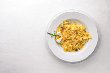 Pasta four cheeses. Italian food. On a wooden background. Top view. Free space for text.