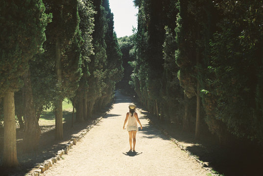 Young girl walking down a path in a Mediterranean forest park