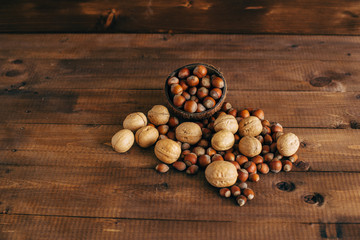 Autumn harvest. Nuts on a wooden background.