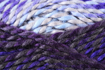 A super close up image of pastel colored yarn 