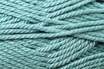 A super close up image of teal yarn