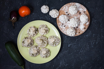 Pile of homemade khinkali dumplings close up on the stone rustic table.