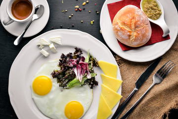 Breakfast. Egg and Burger Beef. Potato frying. On a wooden background. Top view. Free space for text.