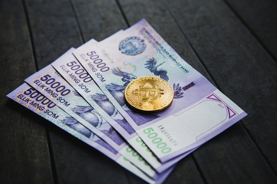 Uzbek banknotes and Bitcoin. Fifty Thousand Uzbek Sums