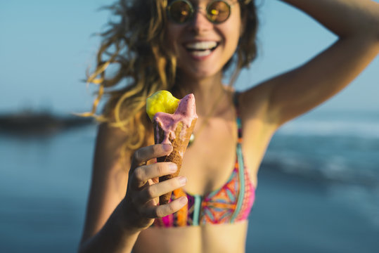 Smiling Woman Enjoying Ice-cream On The Beach.