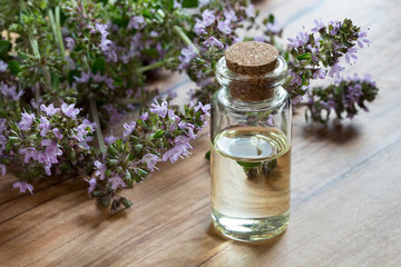Obraz na płótnie Canvas A bottle of thymus serpyllum (Breckland thyme) essential oil