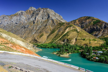 Panoramic view of Charvak Lake, a huge artificial lake-reservoir with azure water created by erecting a high stone dam on the Chirchiq River, located in Tashkent region of Uzbekistan