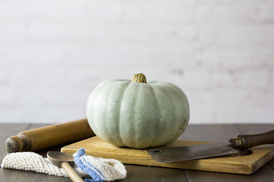 Whole Crown Prince pumpkin with a blue grey skin on kitchen table