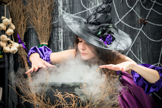 concentrated witch in a hat cooking a love potion