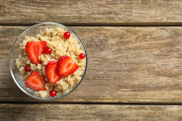 Dessert with quinoa and berries on wooden table