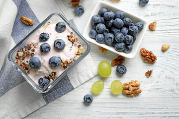 Dessert with quinoa and blueberries on wooden table