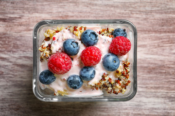 Dessert with quinoa and berries on wooden table