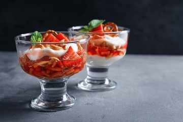 Dessert bowls with strawberry pretzel salad on table