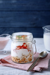 Jar with strawberry pretzel salad on table
