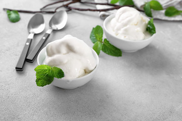 Bowls with yummy vanilla ice cream on kitchen table