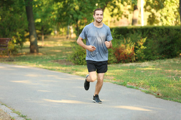 Fototapeta na wymiar Sporty young man running outdoors