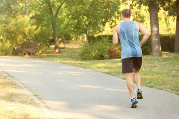 Sporty young man running outdoors