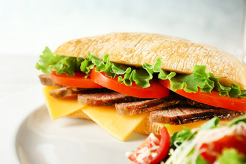 Plate with steak sandwich on table, closeup