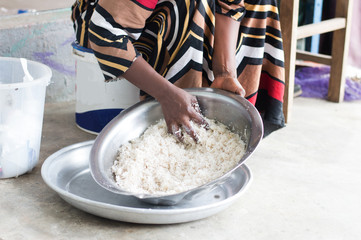 Closeup of woman's hands stirring coconut powder