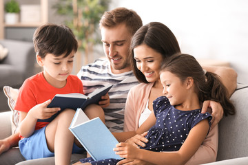 Happy family reading books at home