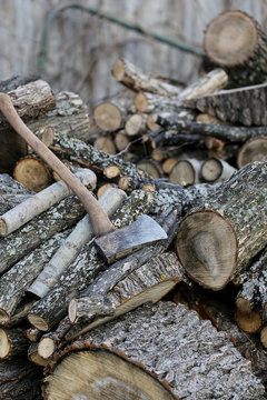 Old wood pile with axe