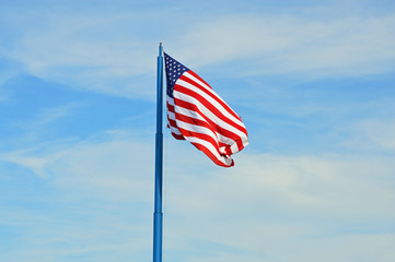 Large American flag waving in the stiff breeze