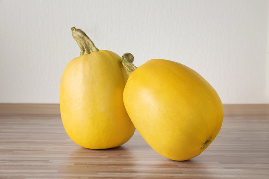 Ripe spaghetti squashes on wooden table