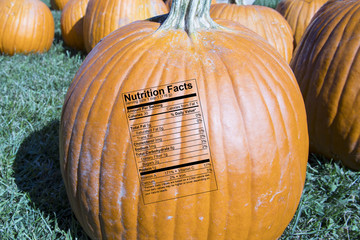 Whole pumpkin with nutrition label in patch at farmers market