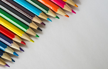 Wooden crayons on a white paper