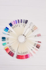 Colorful nails polish palette for manicure. Collection of nails color polish samples, top view. Nail art wheel.