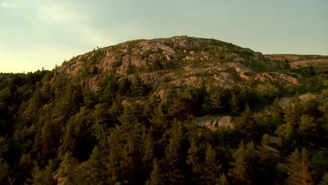 Aerial, peak of Parkman Mountain in Acadia National Park at sunset