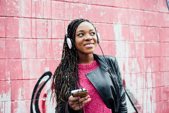 Young african woman enjoying music