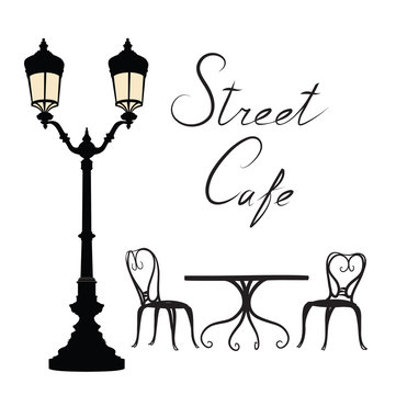 Street cafe - table, chairs, streetlight and lettering City life Cityscape card view