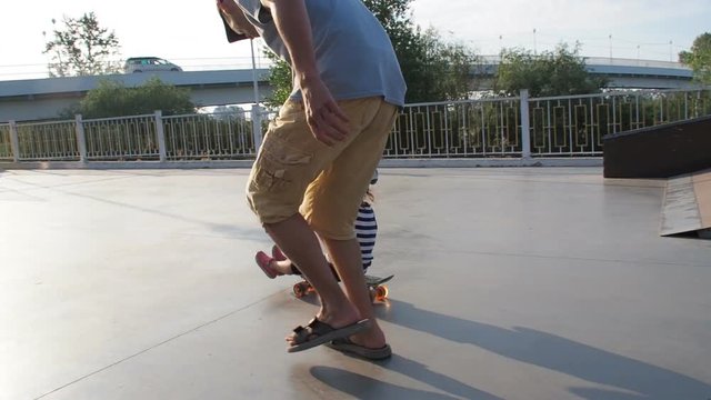 Parents skate the child on a skateboard. A small girl sitting on a skateboard. Three videos in one.