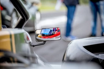 Gordijnen Motorsport car driver detail on rear view mirror © fabioderby