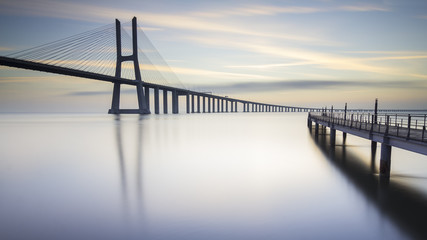 Fototapeta na wymiar asco da Gama Bridge and pier over Tagus River in Lisbon, Portugal, just before sunrise