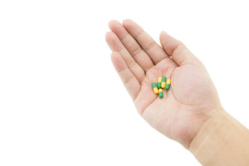 A hand of a man with some capsule pills on white background, clipping part