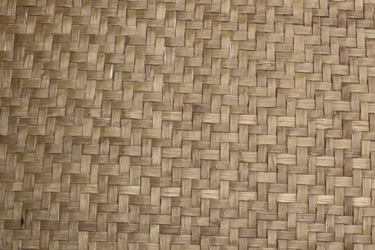   Native Thai style handcraft bamboo weave for Background and backdrop . Texture of handcraft bamboo weave in a neat repeating zig zag pattern.