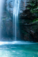 Waterfall in summer time. Long exposure on translucent turqouise water.