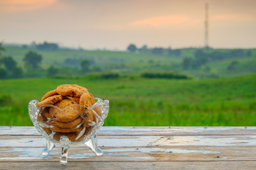 Chocolate cookies on a wooden table with nature background