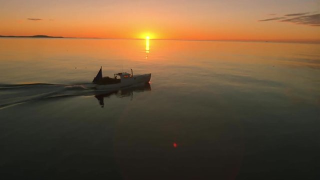 Sunrise over lobster boat on film, aerial