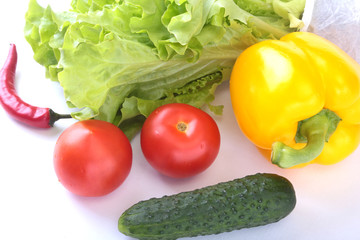 Assorted vegetables, fresh bell pepper, tomato, chilli pepper, cucumber and lettuce isolated on white background. Selective focus.