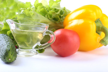 Assorted vegetables, fresh bell pepper, tomato, chilli pepper, cucumber, olive oil and lettuce isolated on white background. Selective focus.
