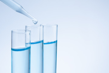 Fototapeta na wymiar Substance over laboratory test tubes