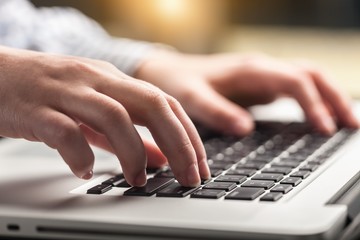 Woman working on laptop.