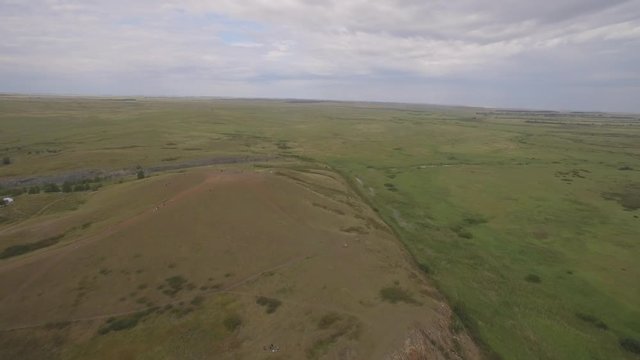 Arkaim in the Urals, aerial view. Spiral of stones on the top of the mountain, People attend a spiritual ritual organized around a spiral of stones