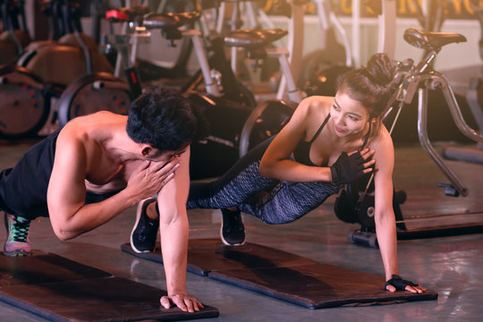 Two asian people sporty put your hands on the floor and hold the shoulder for fitness workout.